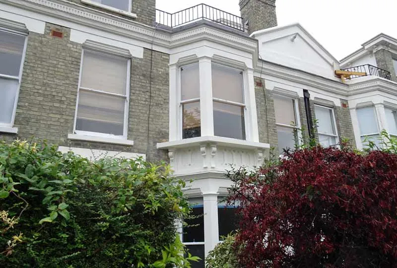 A new upper cast stone bay window in Hackney